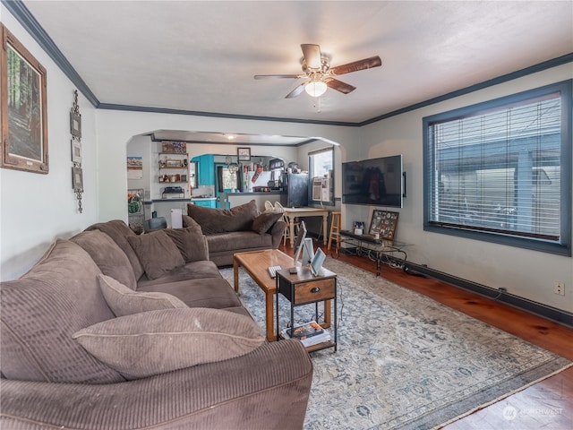 living room with ceiling fan, ornamental molding, and wood-type flooring