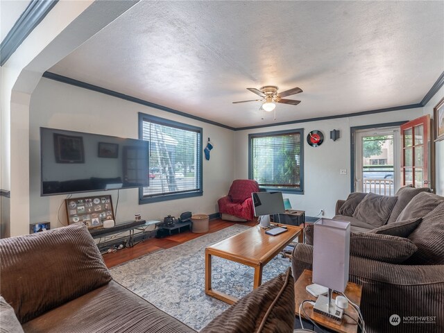 living room with hardwood / wood-style flooring, ornamental molding, a textured ceiling, and ceiling fan