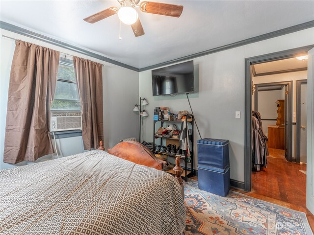 bedroom featuring ceiling fan, crown molding, hardwood / wood-style floors, and cooling unit