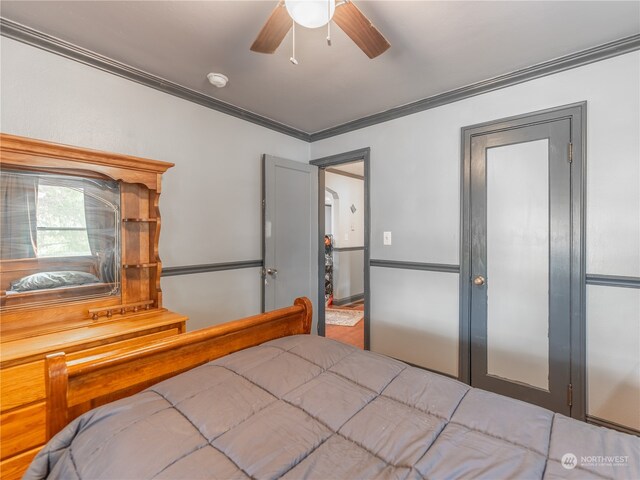 bedroom with ceiling fan and crown molding