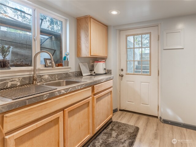 kitchen featuring sink, light hardwood / wood-style flooring, and light brown cabinetry