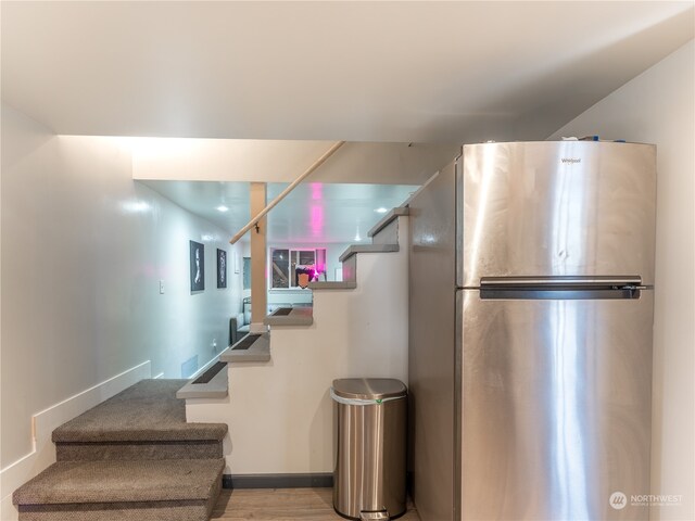 staircase with hardwood / wood-style floors