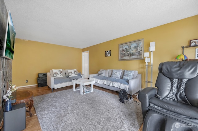 living room featuring a textured ceiling and hardwood / wood-style floors