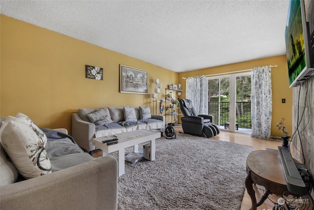 living room featuring a textured ceiling and light hardwood / wood-style flooring