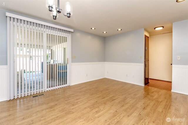 17407 36th Ave E, Tacoma, WA 98446 - unfurnished room with a wainscoted wall, a notable chandelier, wood finished floors, visible vents, and recessed lighting