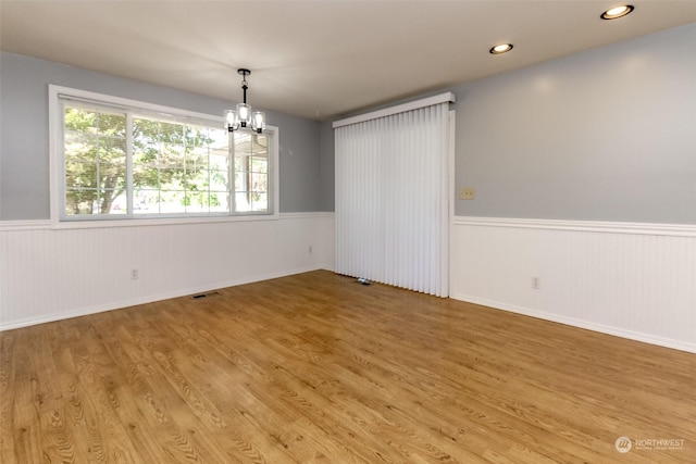17407 36th Ave E, Tacoma, WA 98446 - spare room with a wainscoted wall, a notable chandelier, and light wood-style flooring