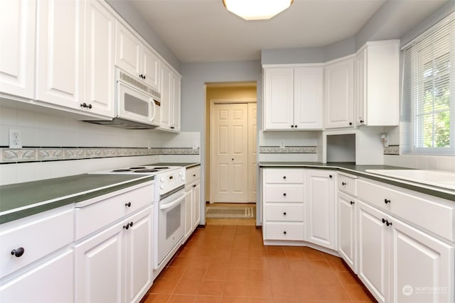 17407 36th Ave E, Tacoma, WA 98446 - kitchen featuring white cabinets, light tile patterned floors, decorative backsplash, and white appliances