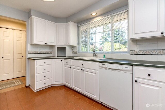 kitchen with dishwasher, white cabinetry, backsplash, and sink