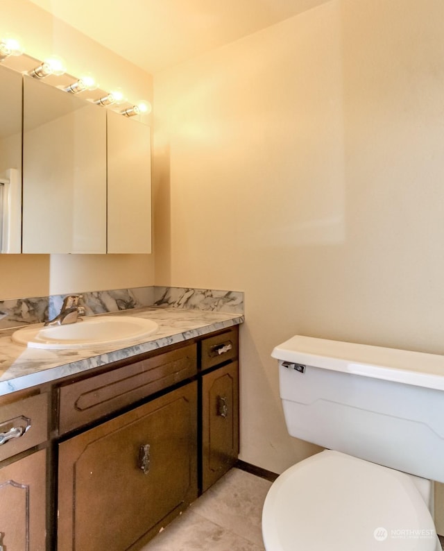 17407 36th Ave E, Tacoma, WA 98446 - bathroom with tile patterned floors, toilet, baseboards, and vanity