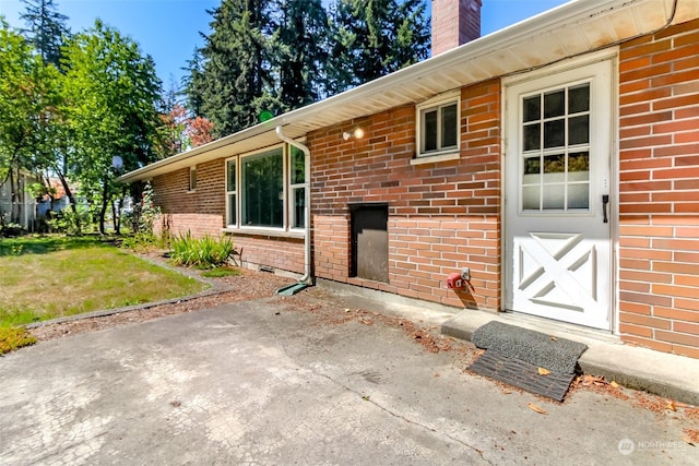 17407 36th Ave E, Tacoma, WA 98446 - doorway to property featuring brick siding, a lawn, and a chimney