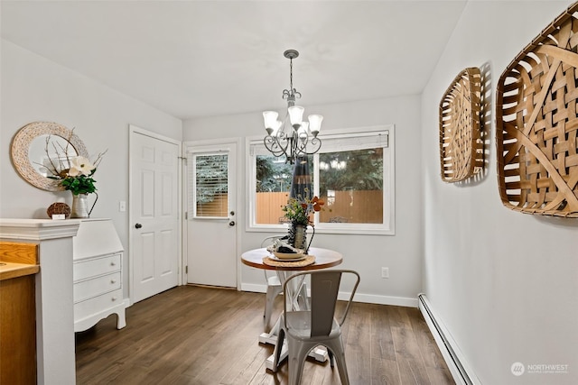 dining room with baseboards, dark wood-style flooring, a baseboard radiator, and a notable chandelier