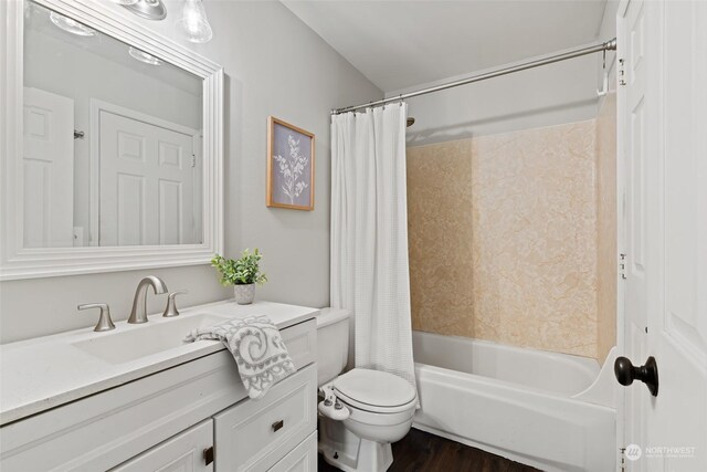 bathroom featuring wood finished floors, shower / bath combo, vanity, and toilet