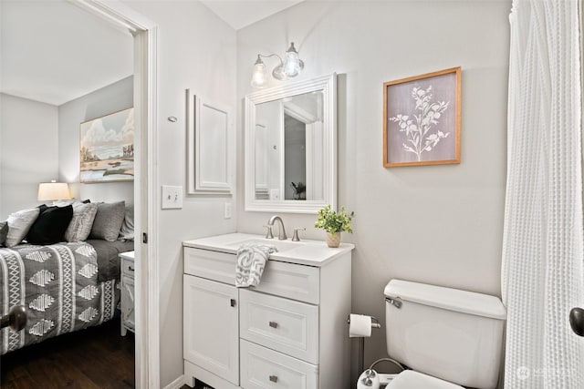 full bathroom featuring toilet, wood finished floors, and vanity