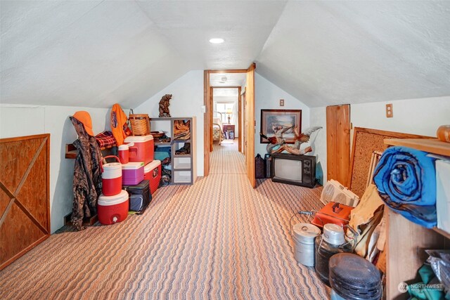 bonus room featuring carpet floors, a textured ceiling, and lofted ceiling