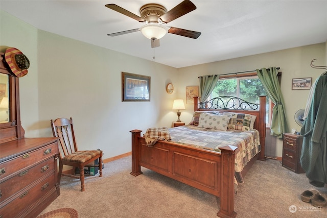 bedroom featuring light carpet, ceiling fan, and baseboards