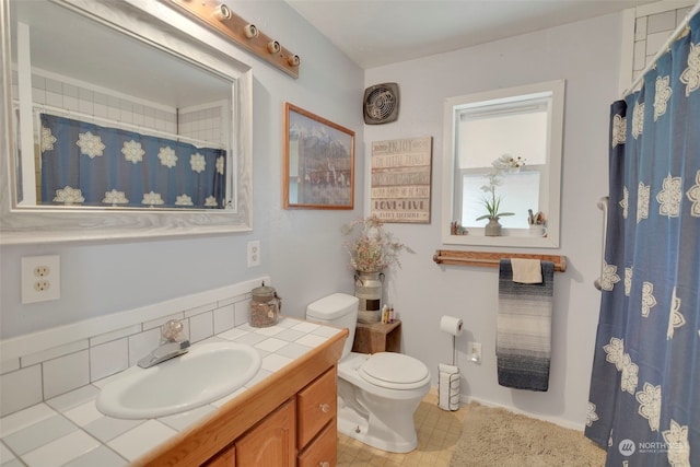 bathroom with toilet and vanity