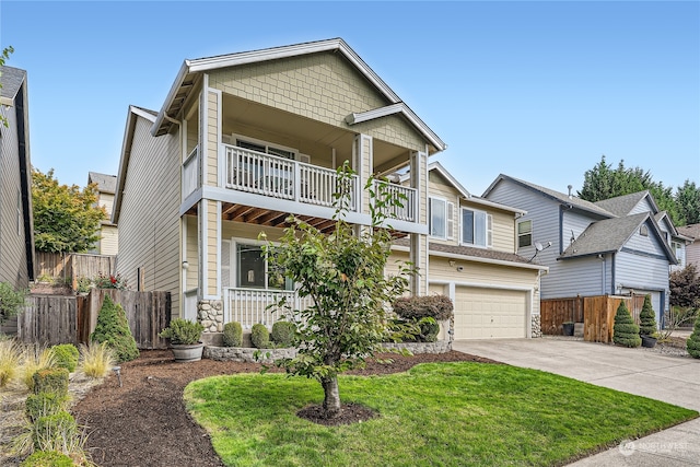 craftsman inspired home with a balcony, a garage, and a front yard