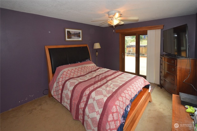 carpeted bedroom with access to exterior and ceiling fan