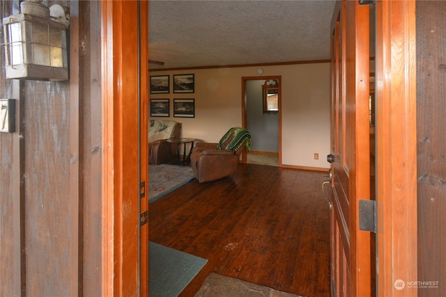 foyer entrance with dark wood-type flooring and a textured ceiling