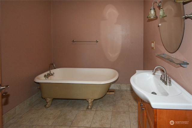 bathroom featuring vanity, a bath, and tile patterned floors