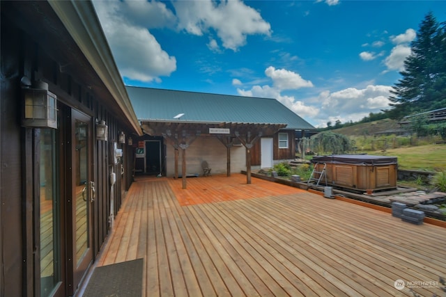 wooden terrace with a pergola and a hot tub