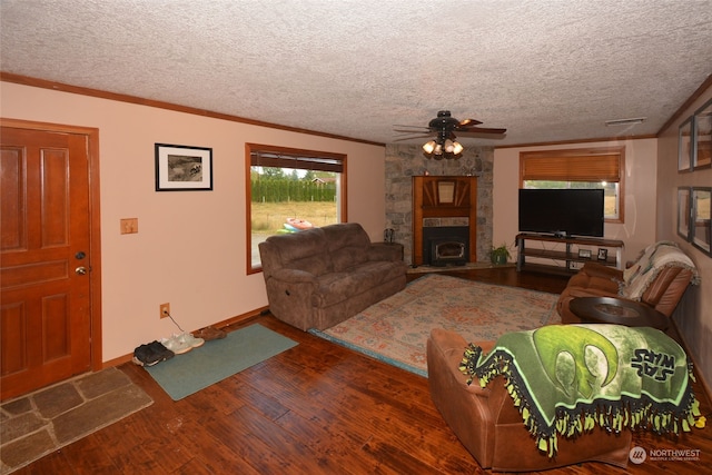 living room featuring a stone fireplace, ceiling fan, dark hardwood / wood-style floors, and a textured ceiling