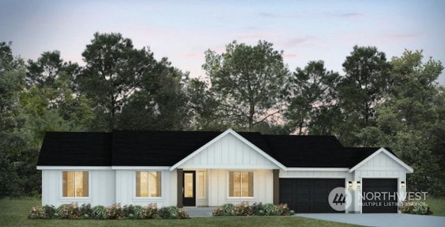 view of front of house with a garage, driveway, and board and batten siding