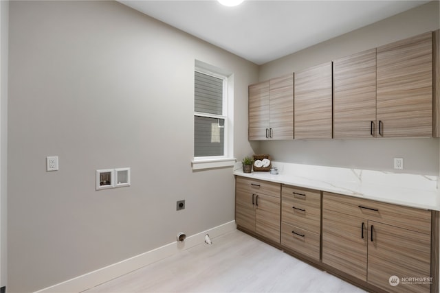 laundry room featuring washer hookup, gas dryer hookup, hookup for an electric dryer, and cabinets