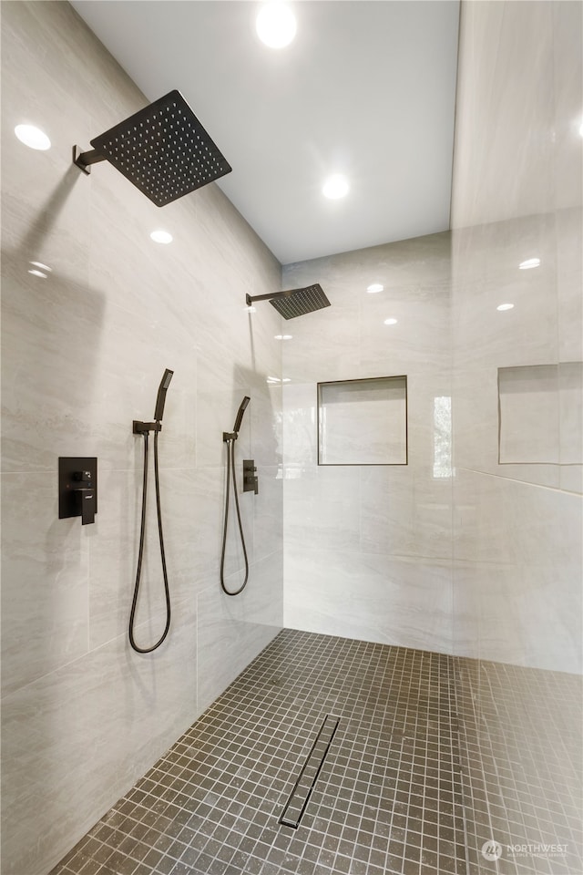 bathroom featuring tile walls and tiled shower