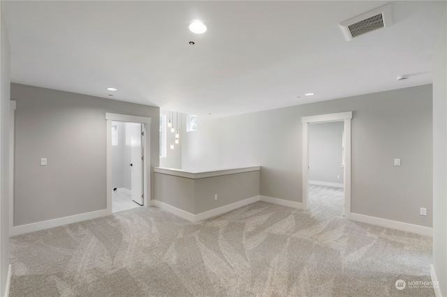 spare room with light colored carpet