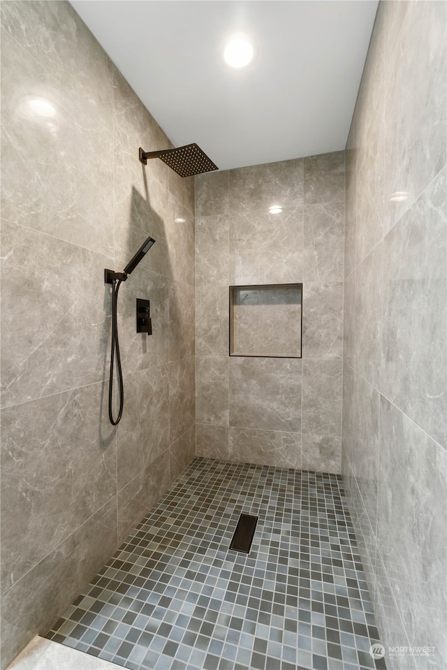 bathroom with tiled shower