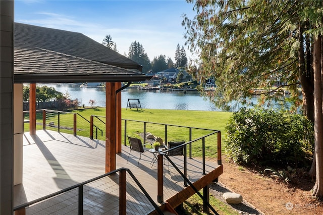 wooden deck with a water view and a yard