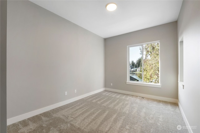 unfurnished room with light carpet