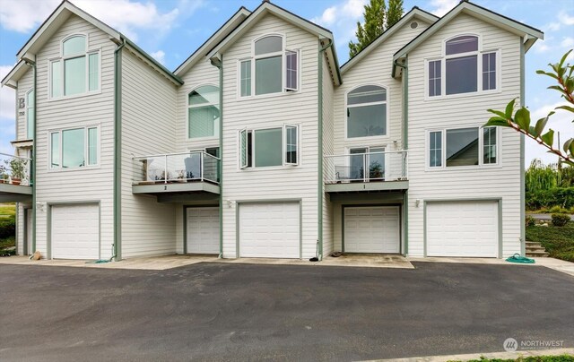 view of front of home featuring a balcony and a garage