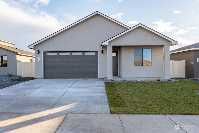 view of front of home featuring a front yard and a garage