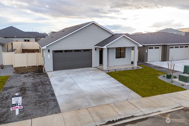 single story home featuring a front lawn and a garage