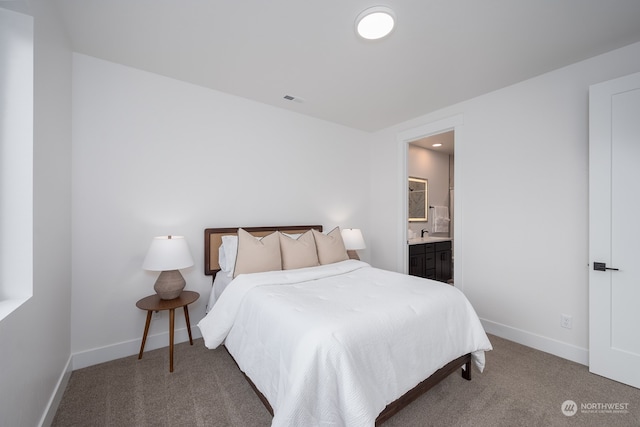 bedroom with carpet floors and ensuite bath