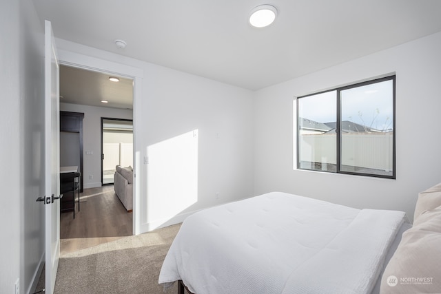 bedroom with dark wood-type flooring