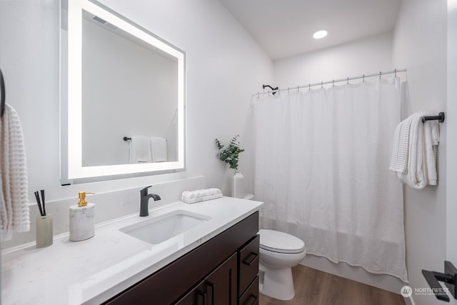 full bathroom featuring wood-type flooring, vanity, toilet, and shower / bath combo