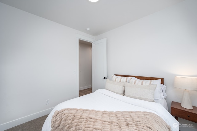 bedroom with dark colored carpet