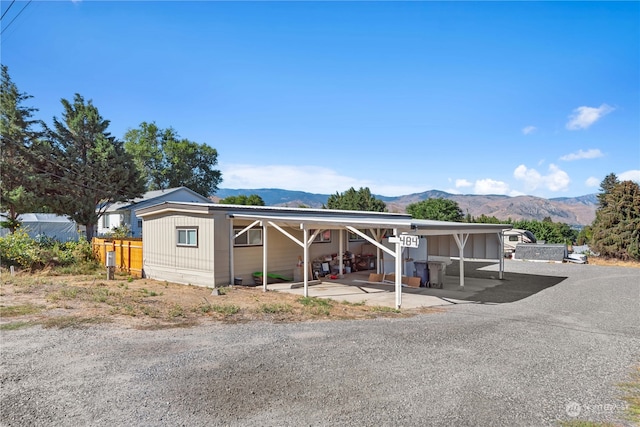 manufactured / mobile home featuring a mountain view and a carport