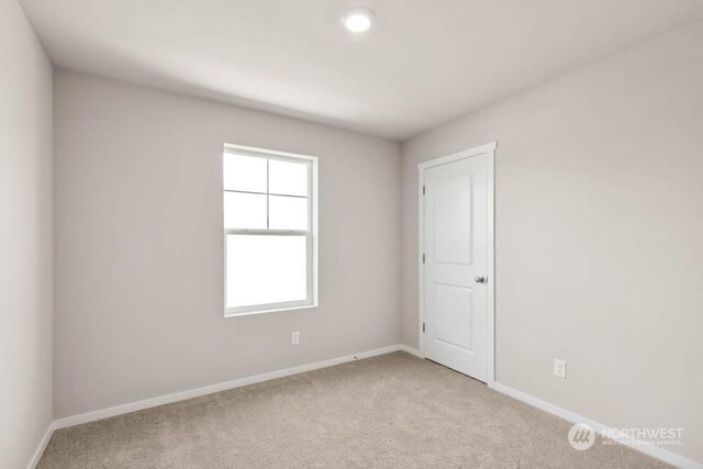 unfurnished room with light colored carpet