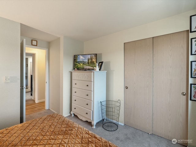 unfurnished bedroom featuring light colored carpet and a closet