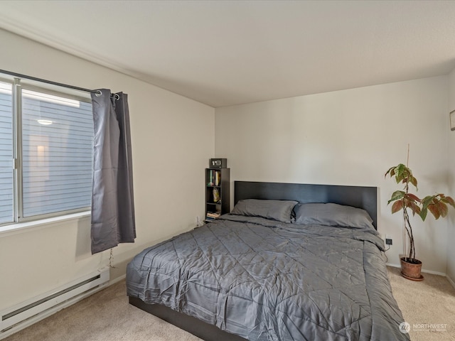 bedroom featuring a baseboard heating unit, carpet, and multiple windows