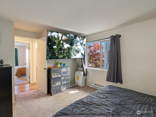 bedroom with a baseboard radiator and carpet flooring