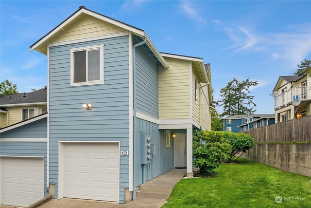 front of property with a garage and a front lawn