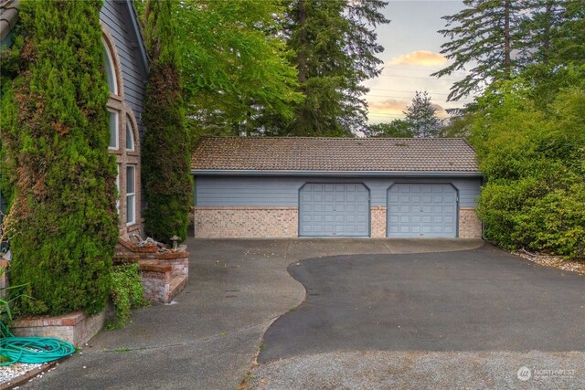 view of garage at dusk