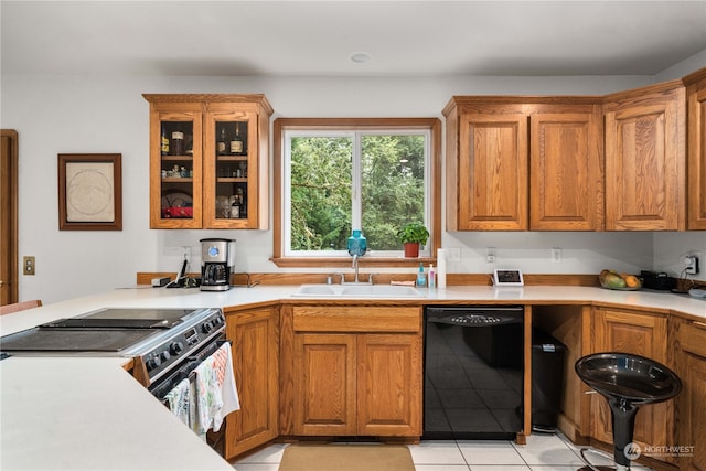 kitchen featuring black appliances, sink, and light tile patterned floors