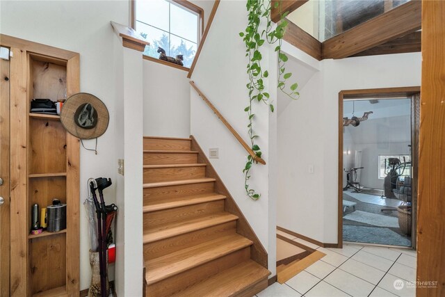 stairs with tile patterned flooring and a wealth of natural light