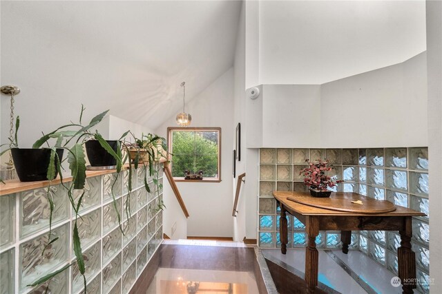 hallway featuring hardwood / wood-style floors and high vaulted ceiling